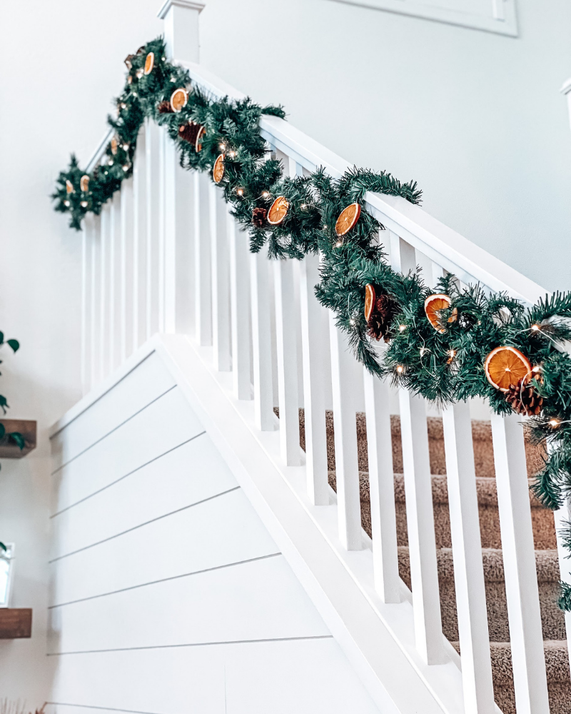 decorated staircase banister christmas garland dried orange garland
